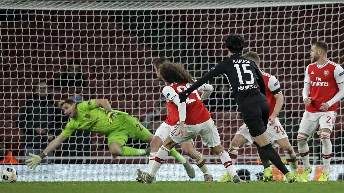 Frankfurt's Daichi Kamada scores his second goal against Arsenal's goalkeeper Emiliano Martinez during the Europa League Group F soccer match between Arsenal and Eintracht Frankfurt