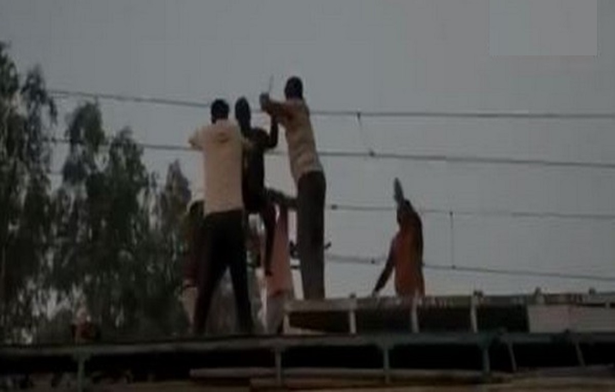 Video shows dramatic rescue of man dangling from overhead wire on tracks