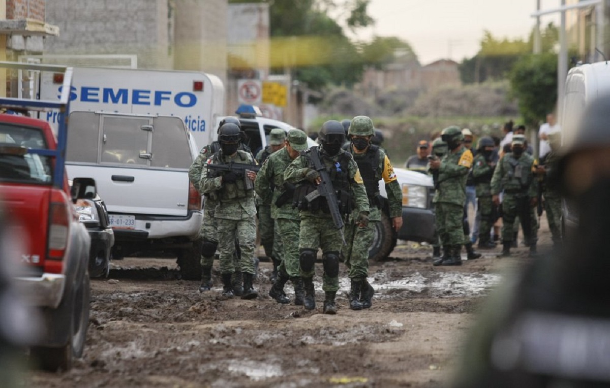 Members of the national guard walk near an unregistered drug rehabilitation center after a shooting in Irapuato, Mexico, Wednesday, July 1, 2020. Gunmen burst into the rehab center and opened fire, killing more than 20 and wounding several more.