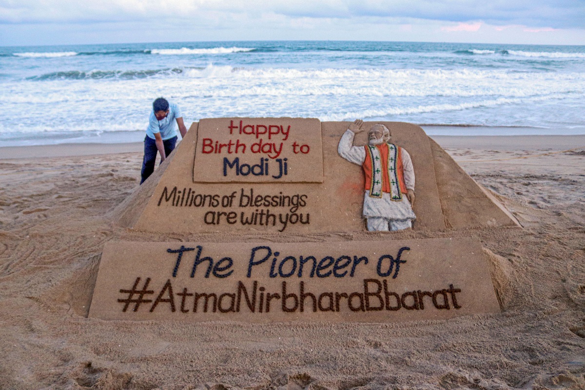 Puri: Sand artist Sudarsan Pattnaik gives finishing touch to a sand sculpture dedicated to PM Narendra Modi, ahead of his birthday, in Puri, Wednesday, Sept. 16, 2020.