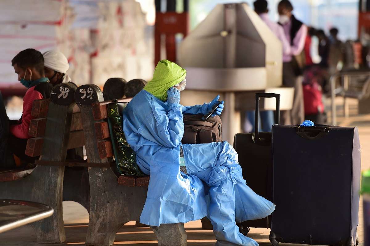 New Delhi: A woman passenger wearing a protective suit, waits for a train at New Delhi station, Monday, Nov 2, 2020. The daily positivity rate rose to 12.69% on Sunday as Delhi reported 5,664 new Covid-19 cases from 44,623 tests conducted in the last 24 hours.