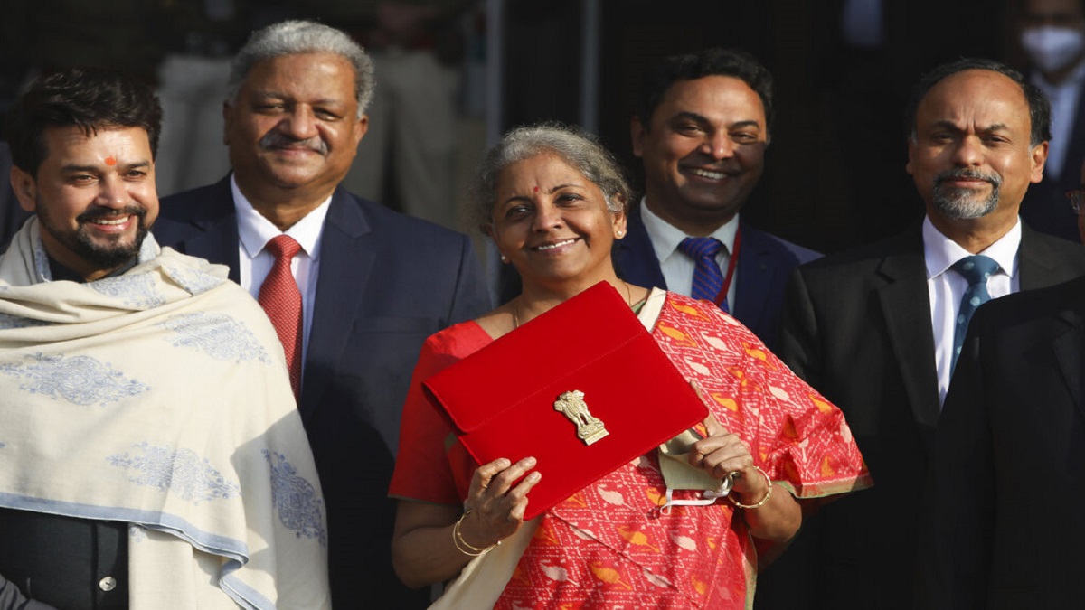 Finance Minister Nirmala Sitharaman, center, with junior Finance Minister Anurag Thakur, left, leave finance ministry for the parliament house to present annual federal budget, in New Delhi.