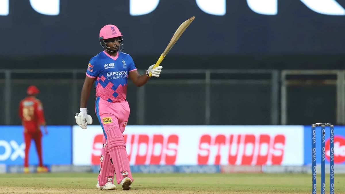Rajasthan Royals captain Sanju Samson raises his bat after scoring a hundred against Punjab Kings in Mumbai on Monday night.