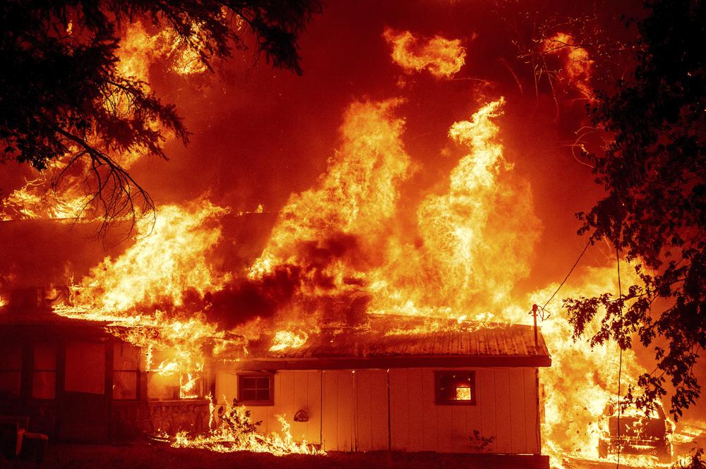 California's largest fire burns homes as blazes scorch West