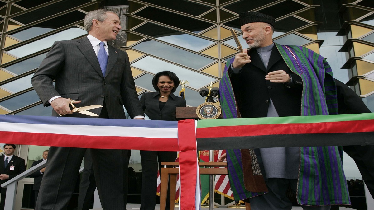 In this March 1, 2006 file photo, U.S. President George W. Bush, left and Afghan President Hamid Karzai get ready to cut a ribbon to officially open the U.S. Embassy in Kabul, Afghanistan.