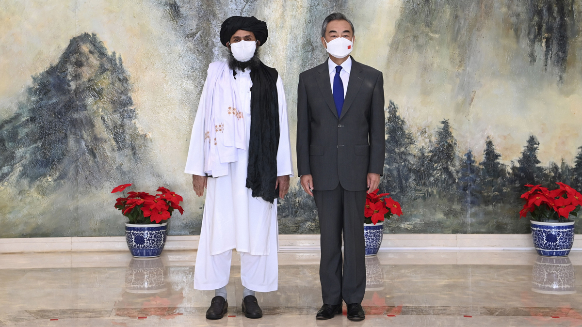 Taliban co-founder Mullah Abdul Ghani Baradar and Chinese Foreign Minister Wang Yi pose for a photo during their meeting in Tianjin, China, on Wednesday (July 28, 2021).