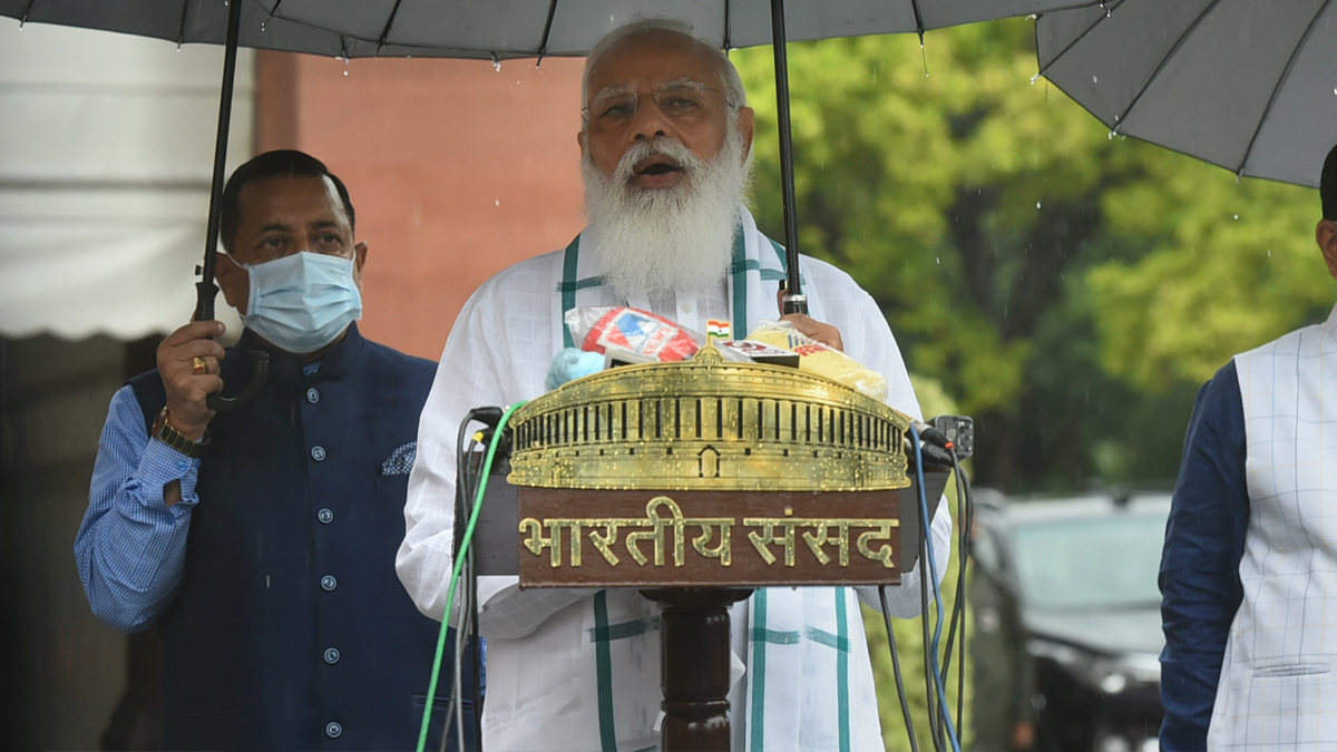 Holding umbrella by self, PM Modi addresses media in rain ahead of monsoon  session of parliament