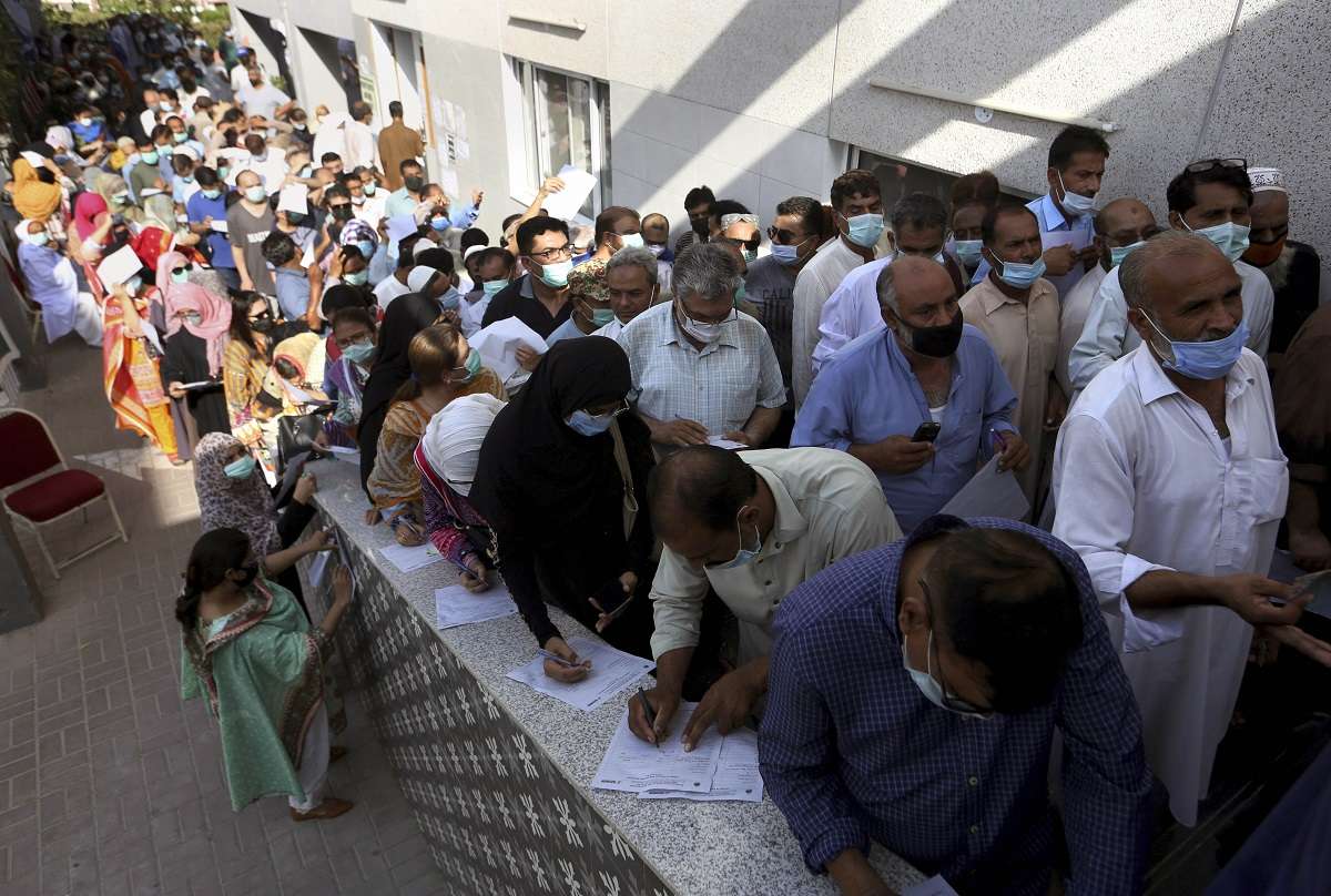 Karachi: People stand in queues while they wait their turn to receive COVID vaccine