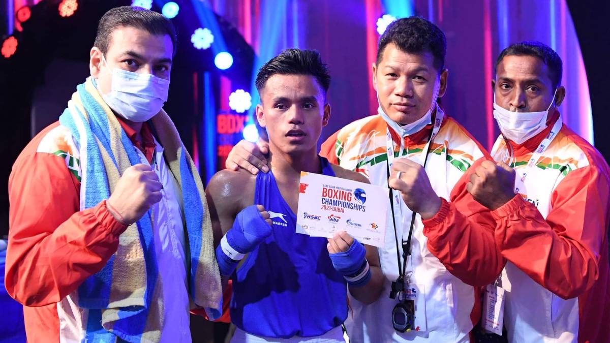 Bishwamitra Chongtham (centre) with the Indian coaching staff after his win on Monday.