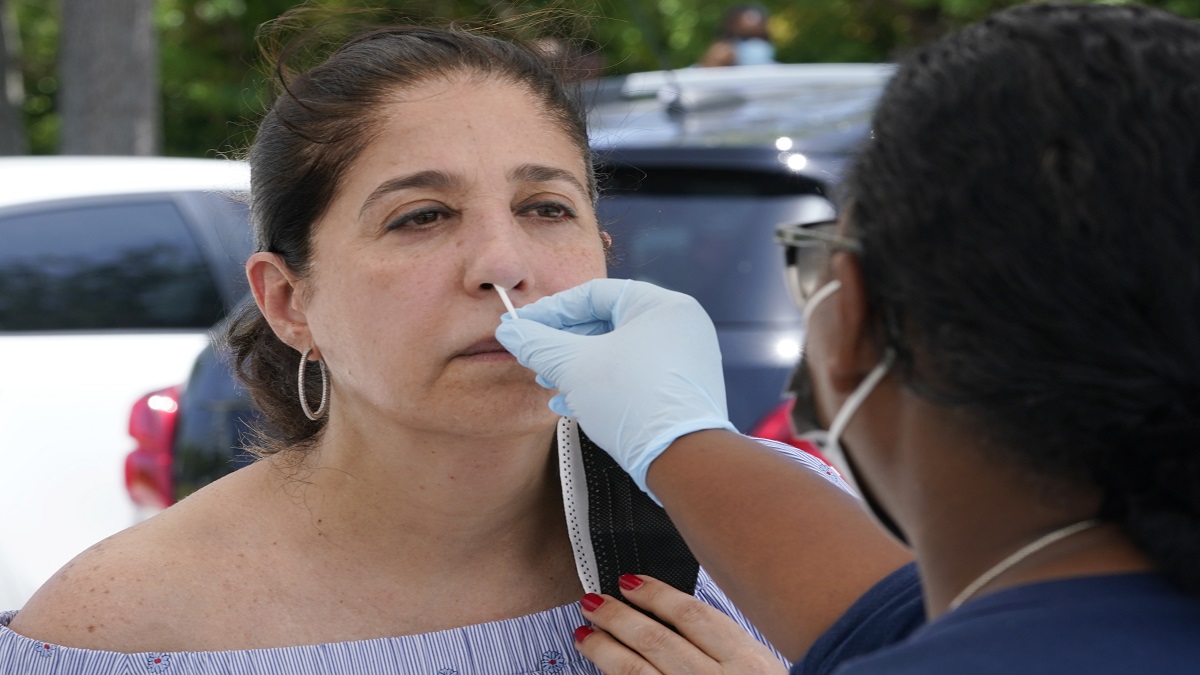 FILE | Raquel Heres gets a COVID-19 rapid test to be able to travel overseas, Saturday, July 31, 2021, in North Miami.&nbsp;