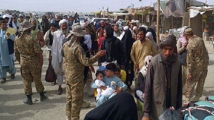 Pakistan soldiers check documents of travelers crossing the border to Afghanistan through a crossing point in Chaman, Pakistan.