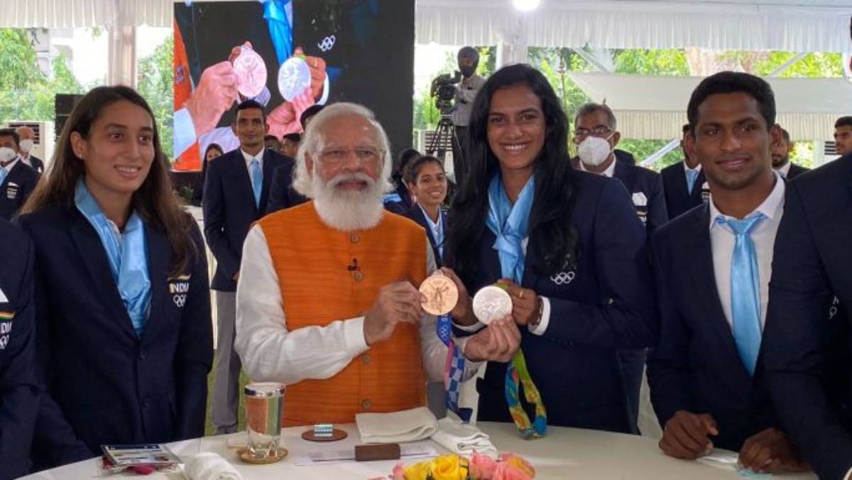 PM Narendra Modi (centre) poses with PV Sindhu and her two Olympic medals in New Delhi on Monday morning.