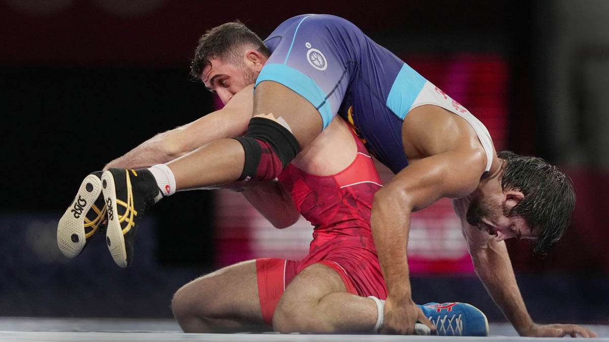 India's Bajrang Punia competes against Haji Aliyev of Azerbaijan in the semi-finals during their mens freestyle 65kg wrestling match at the 2020 Summer Olympics, in Japan, Friday, Aug. 6