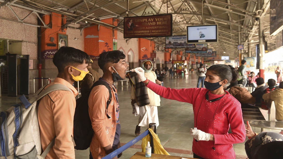 A medical worker collects swab sample of a passenger for Covid-19 test&nbsp;