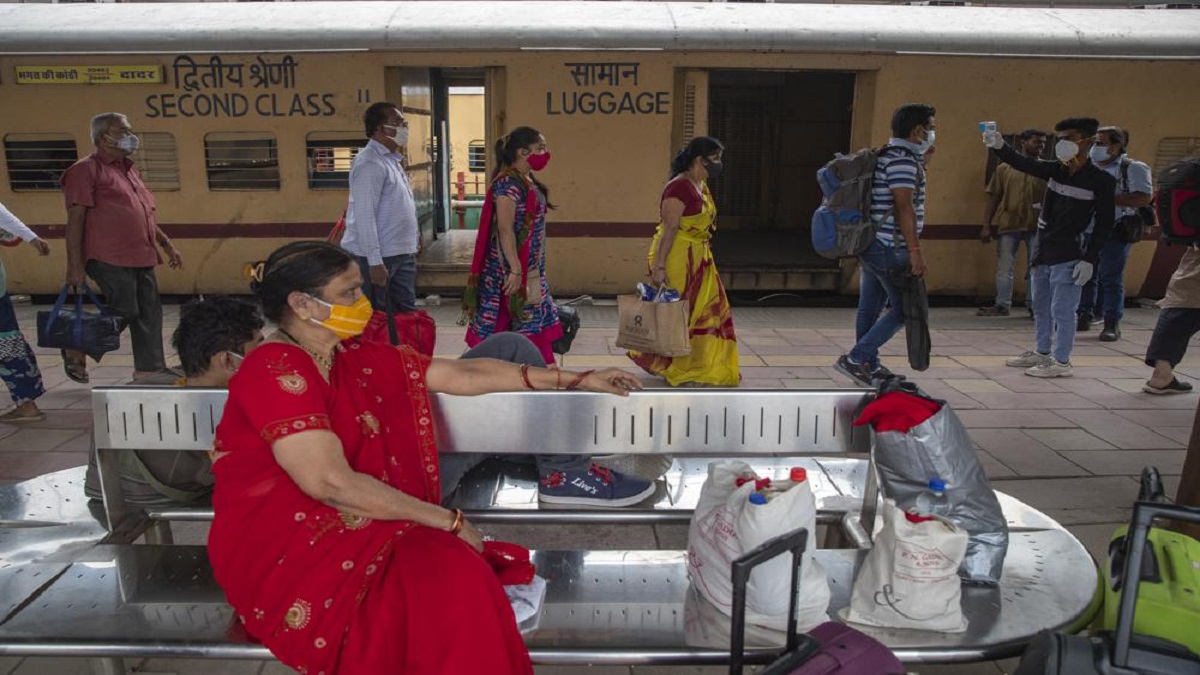A health worker checks body temperature of travelers as precaution against coronavirus before allowing them to proceed at station in Mumbai.&nbsp;