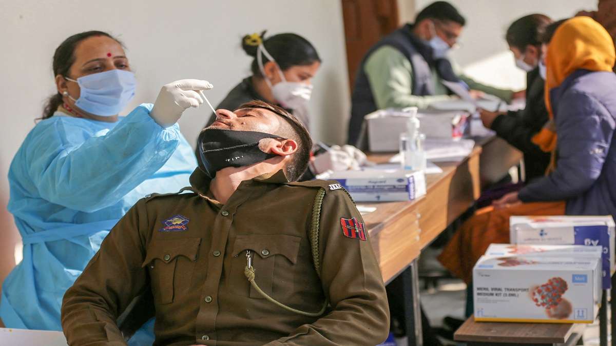 A healthcare worker collects swab samples of a policeman for Covid test amid concern over rising Omicron cases in Jammu.&nbsp;
&nbsp;