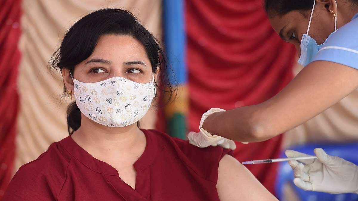 A health worker administers a dose of COVID vaccine to a woman, at 19th Mega Vaccine Drive, at IIT-Madras campus, in Chennai.&nbsp;
&nbsp;