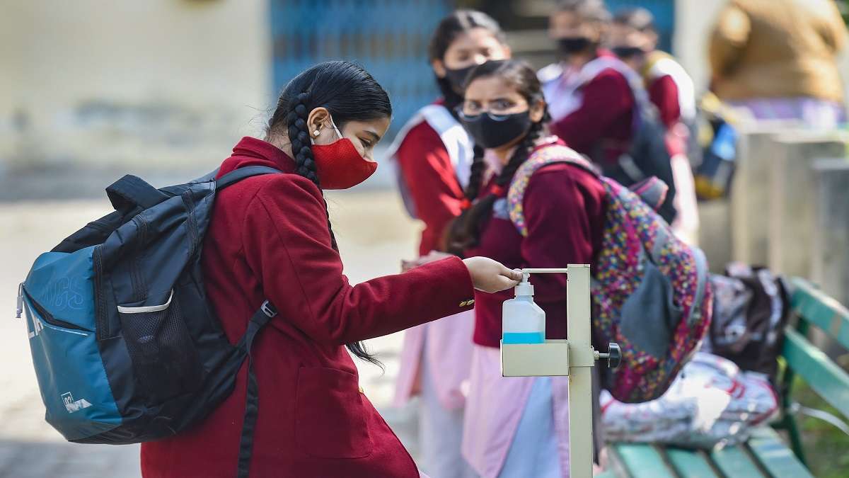 New Delhi: Students sanitise their hands before entering the premises, after schools reopened following ease in COVID-induced restrictions