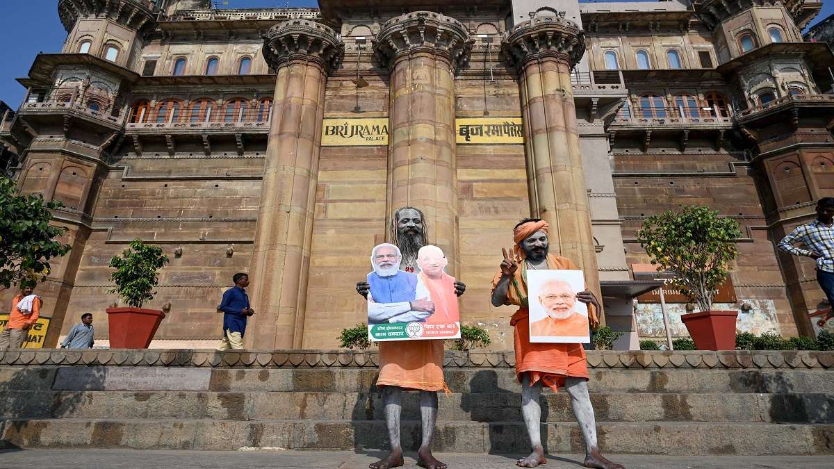 Sadhus holding cut outs and photographs of PM Narendra Modi and UP CM Yogi Adityanath pose for photographs, after BJPs win in state assembly polls.&nbsp;