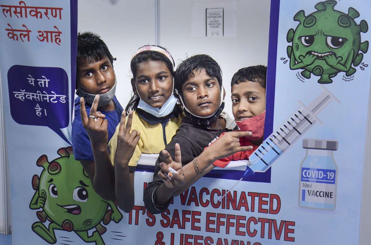 Thane: Students pose for photos after receiving a dose of Covid-19 vaccine at a vaccination centre in a parking plaza