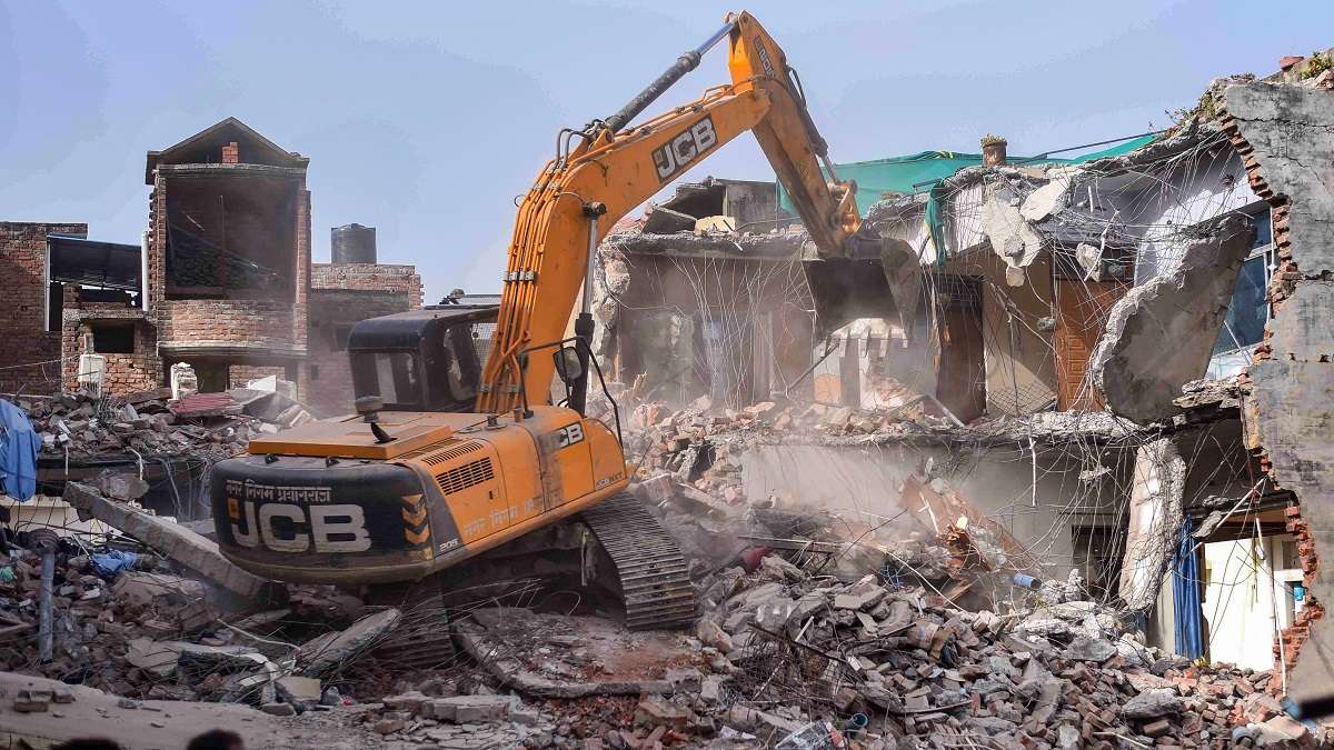 Bulldozer being used to demolish the illegally constructed residence of Javed Ahmed, a local leader who was allegedly the key conspirator of violent protests against now-suspended BJP leaders remarks on Prophet Muhammad, in Prayagraj, Sunday, June 12, 2022.&nbsp;