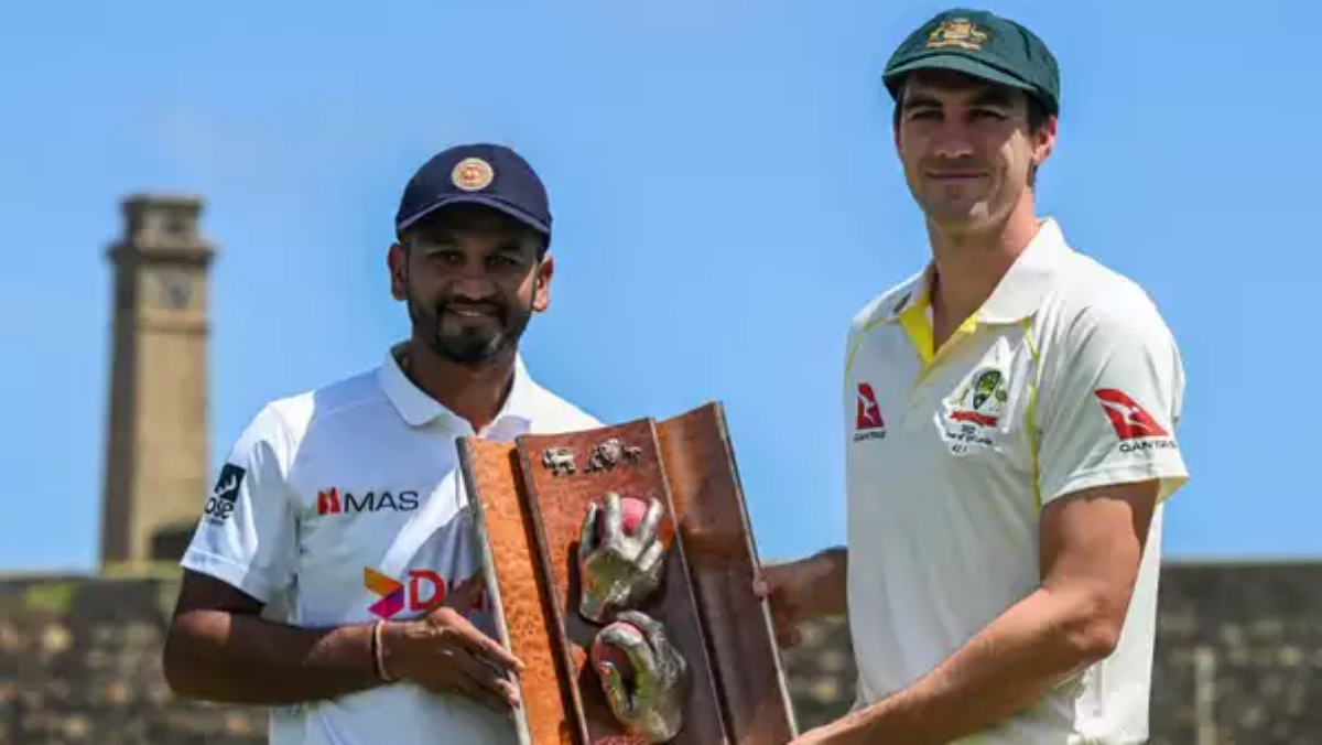 Sri Lanka skipper Dimuth Karunaratne along with his Australian counterpart Pat Cummins pose with the series trophy.
