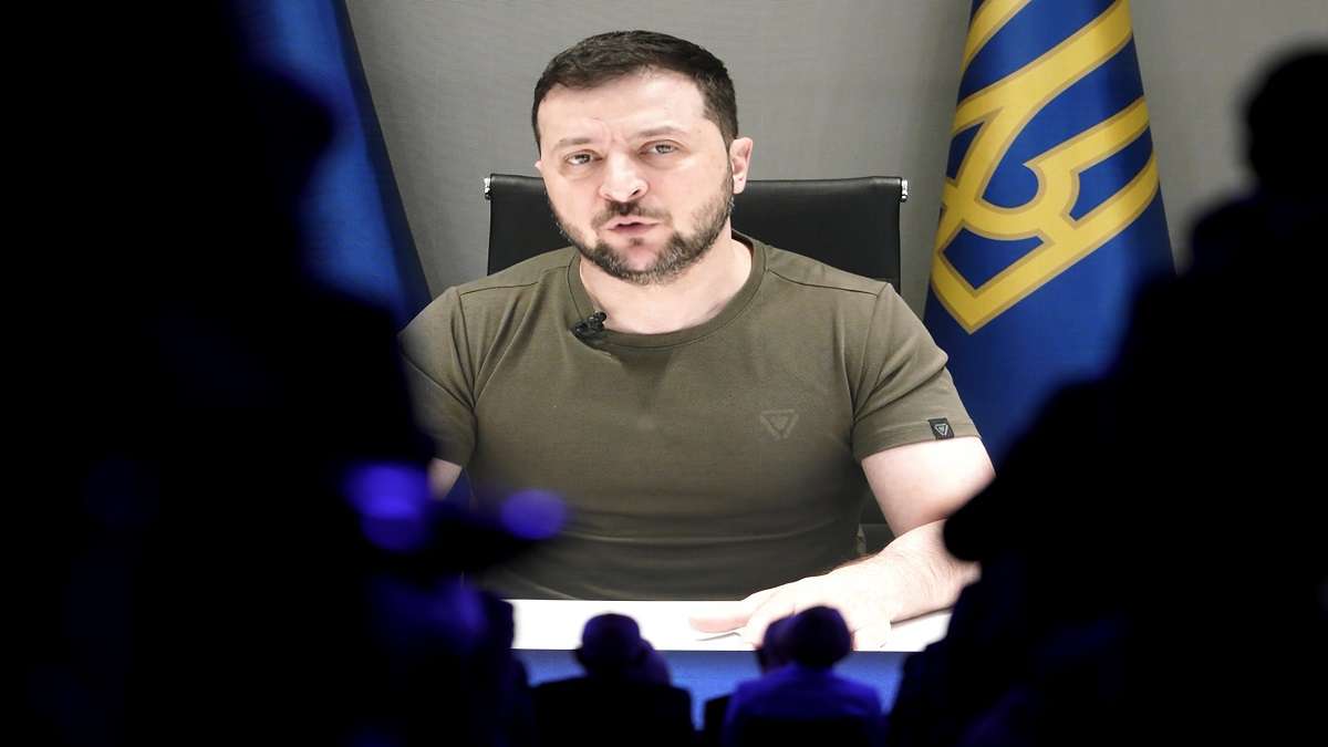 Ukrainian President Volodymyr Zelenskyy displayed on a screen as he addresses the audience from Kyiv on a screen during the World Economic Forum in Davos, Switzerland.&nbsp;