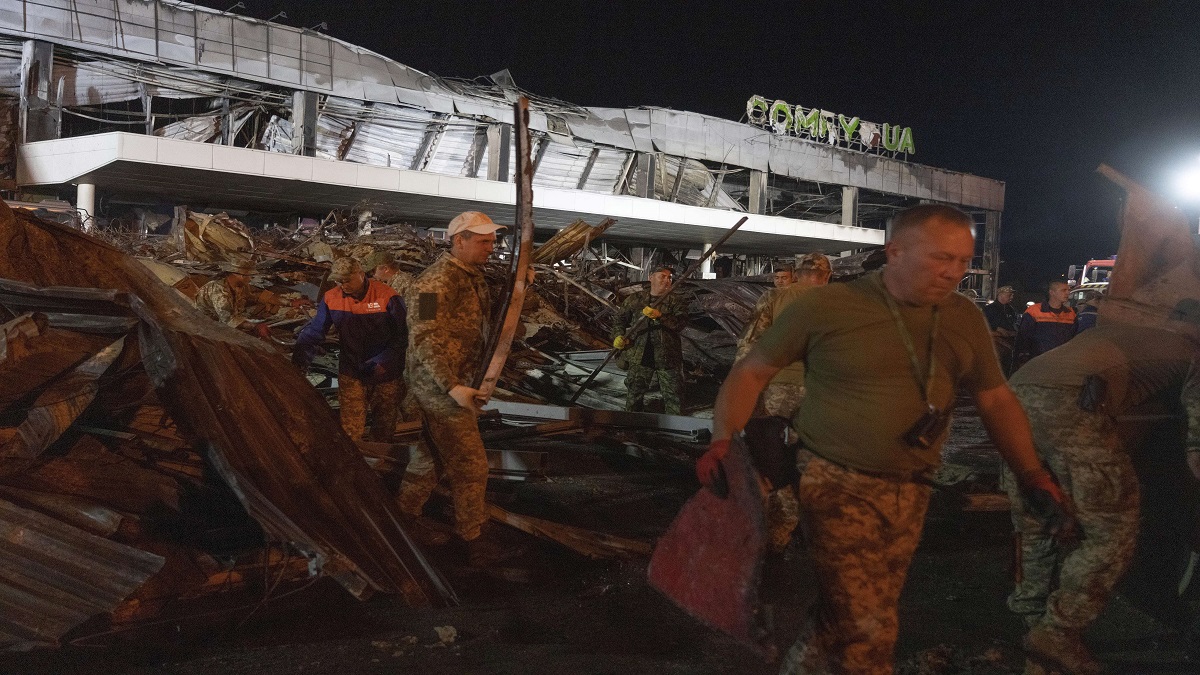 Ukrainian State Emergency Service firefighters work to take away debris at a shopping center burned after a rocket attack in Kremenchuk, Ukraine.
&nbsp;