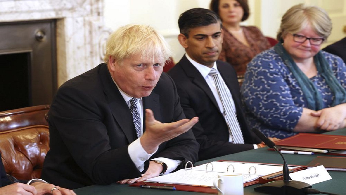 Britain's Prime Minister Boris Johnson left, and Britain's Chancellor of the Exchequer Rishi Sunak, centre, take part in a cabinet meeting.