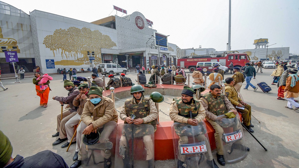 Bihar Police personnel sits outside the railway junction during Bihar bandh, in Patna. 