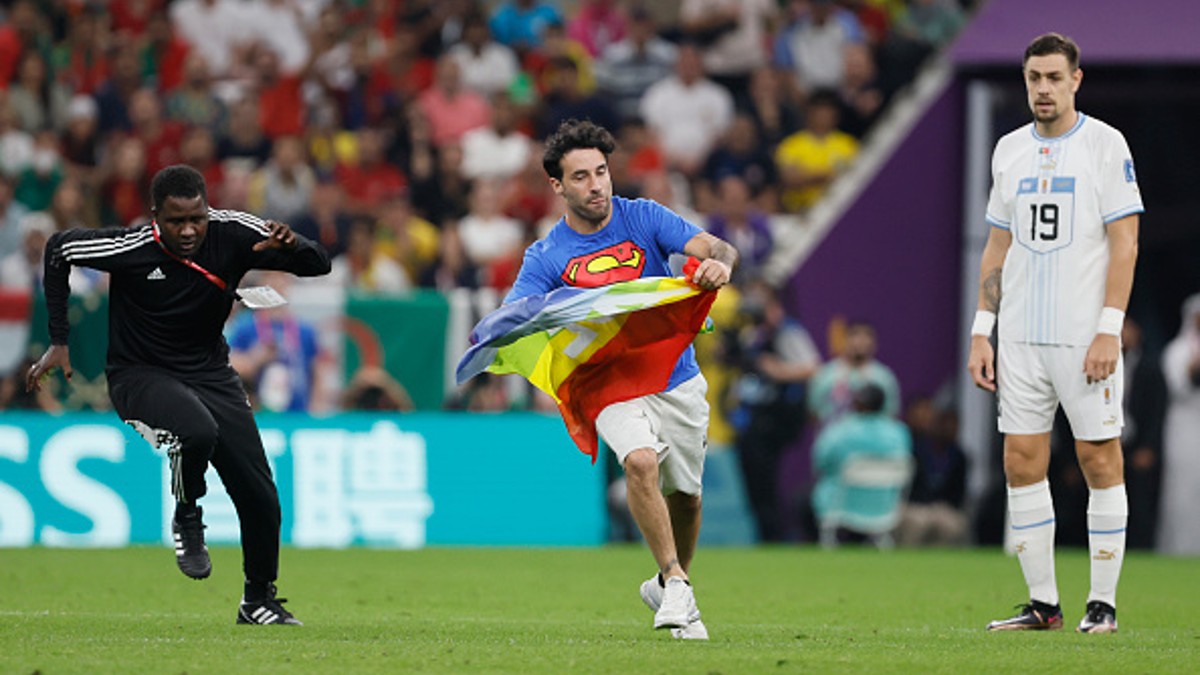 World Cup 2022 pitch invader wears 'Save Ukraine' shirt and holds pride  flag during Portugal vs Uruguay