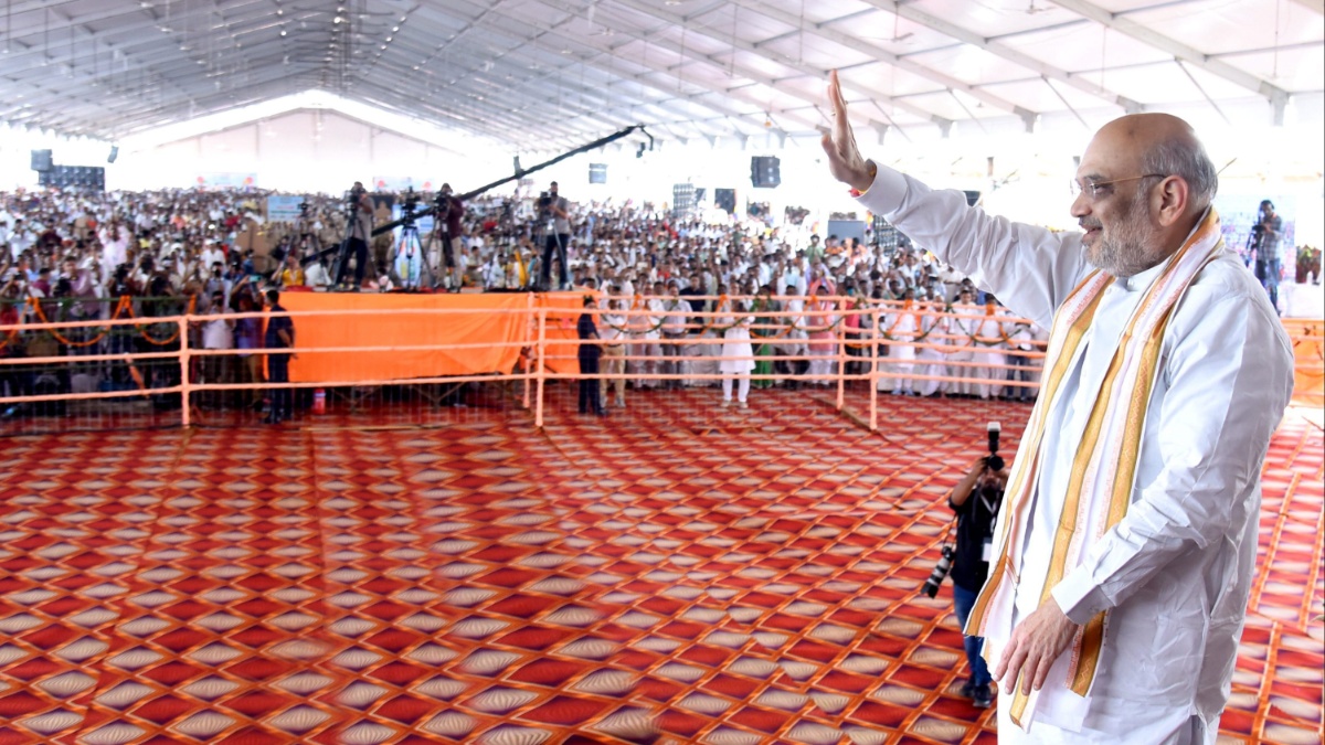 Union Home Minister Amit Shah waves at farmers.