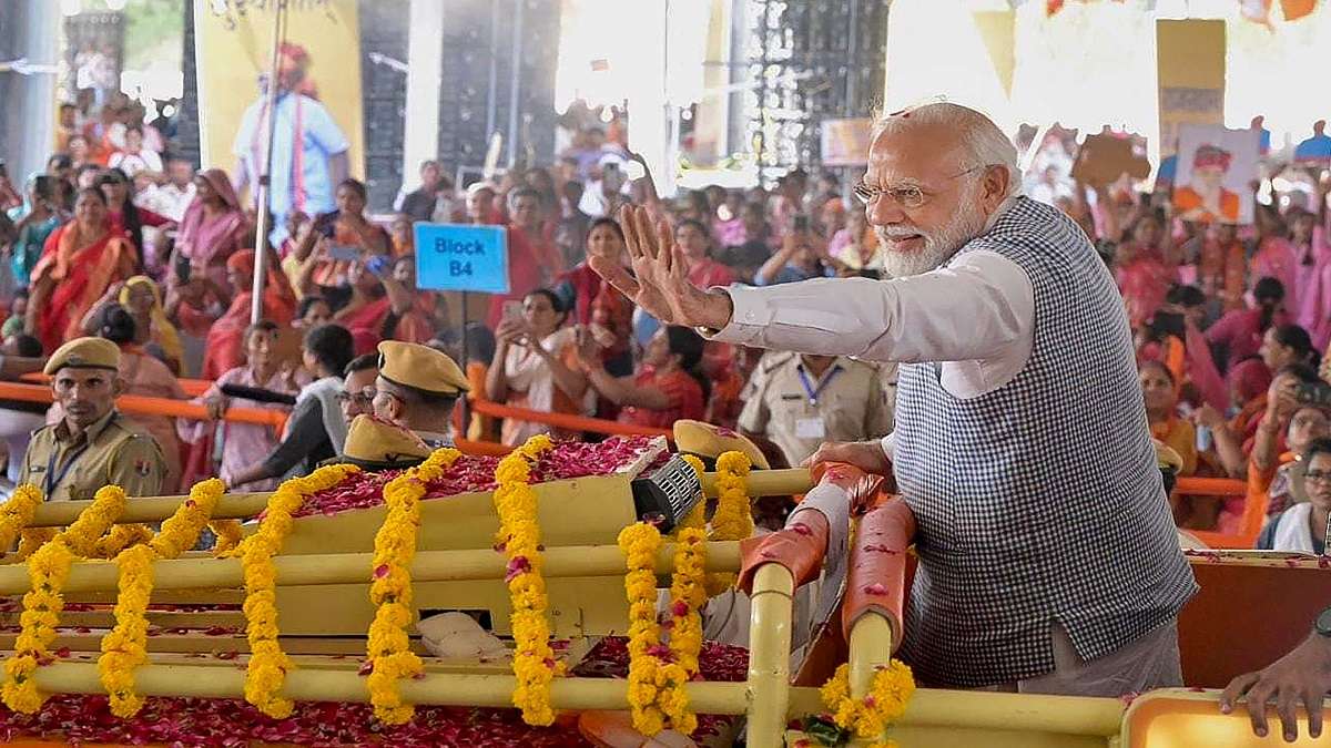 Prime Minister Narendra Modi waves at the crowd as he arrives for a public meeting in Jodhpur