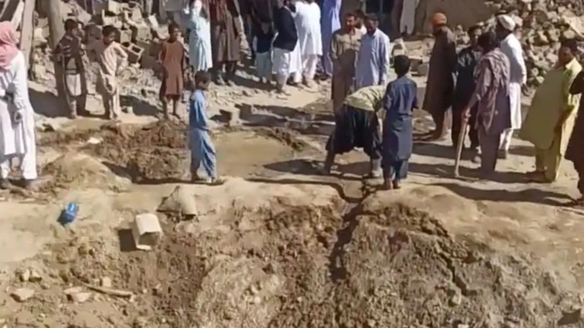 People gather near rubble in the aftermath of Pakistan's military strike on an Iranian village near Saravan, Sistan and Baluchestan.