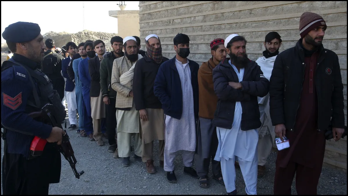 People line up to cast their votes in Pakistan amid tight security.