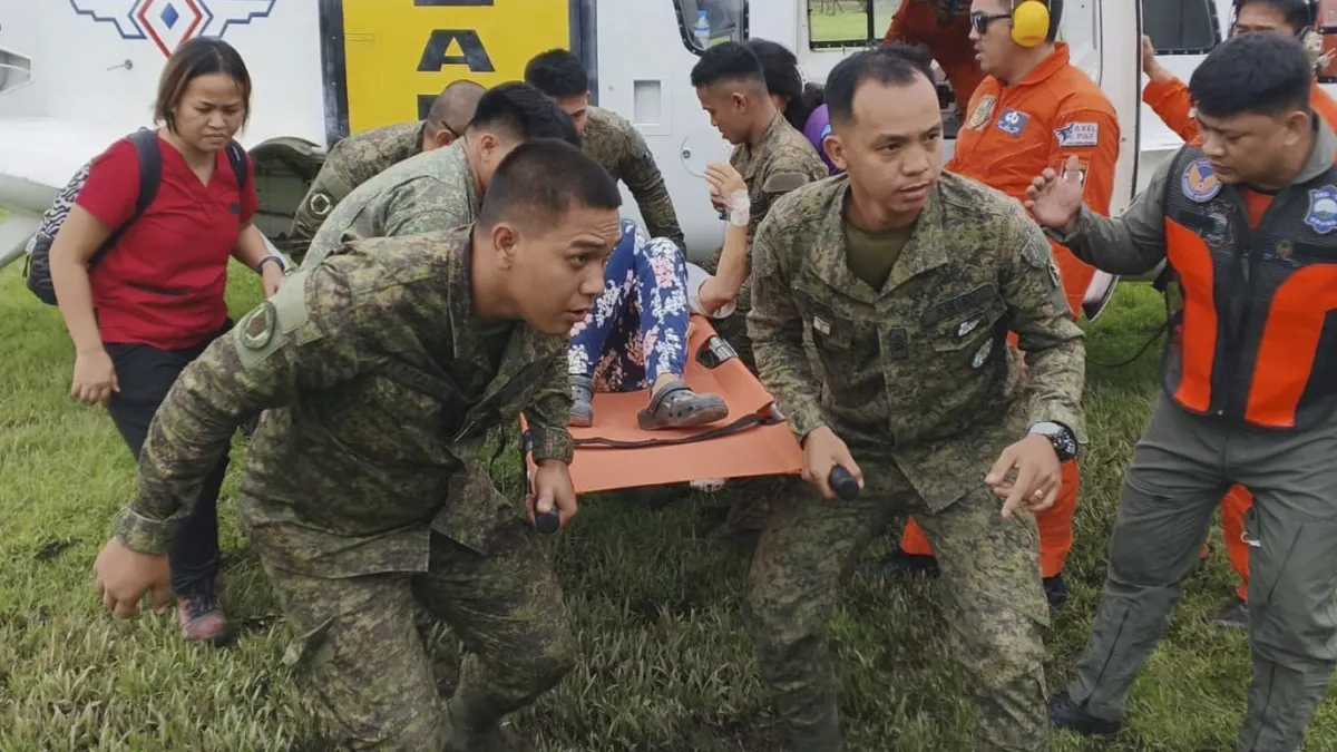 Philippines soldiers rescue a landslide victim on Wednesday.