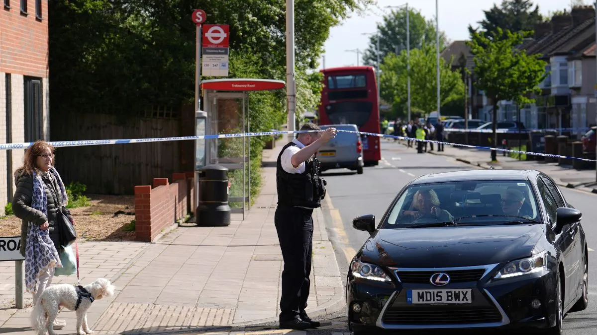 Police talking to members of the public at the scene in Hainault, north east London after reports of several people being stabbed at a Tube station.