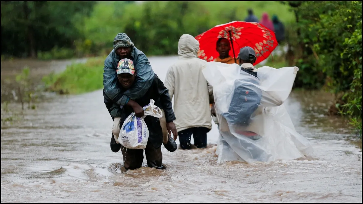 Residents forced to wade through flood waters in Kenya.