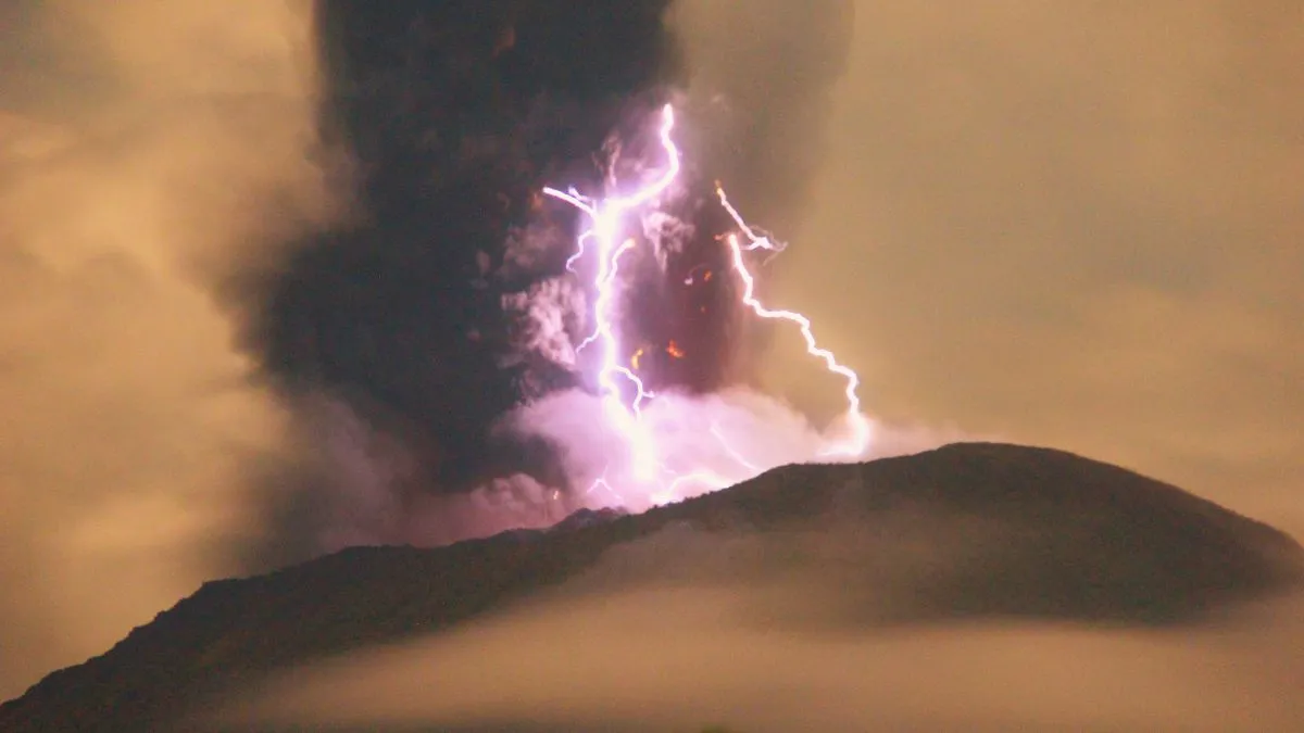 Lightning appears amid a storm as Mount Ibu spews volcanic material during an eruption, in Indonesia