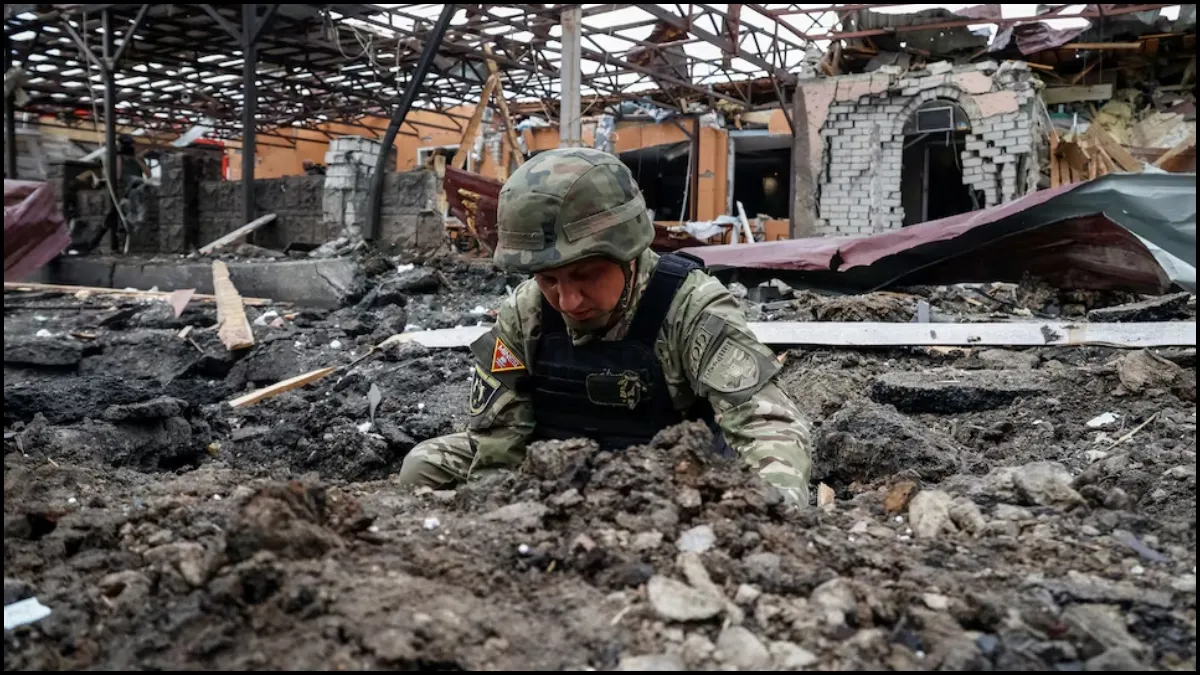 A Police bomb squad member works at the site of a Russian air strike on Thursday.