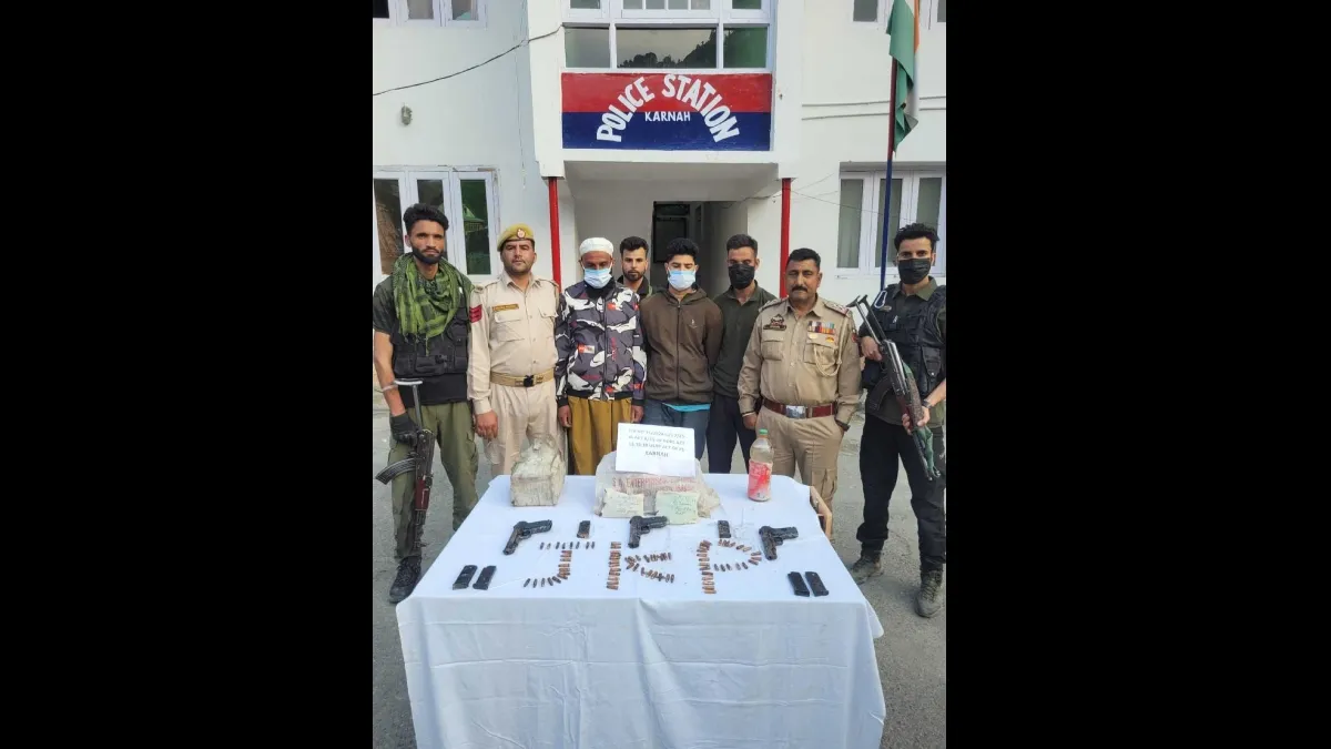 Arrested accused in police custody with confiscated arms, explosives and drugs