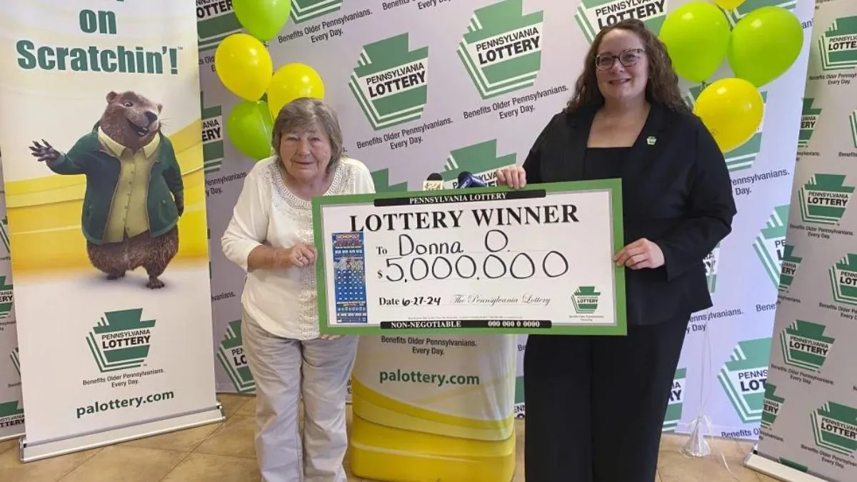 Donna Osborne, 75, left, posing for a photo with PA Lottery Deputy Director of Corporate Sales Staci Coombs at Lottery Headquarters in Middletown