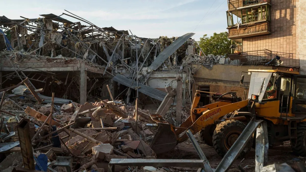 A tractor clears the rubble after a Russian strike on the Sapphire hotel in Kramatorsk, Donetsk region
