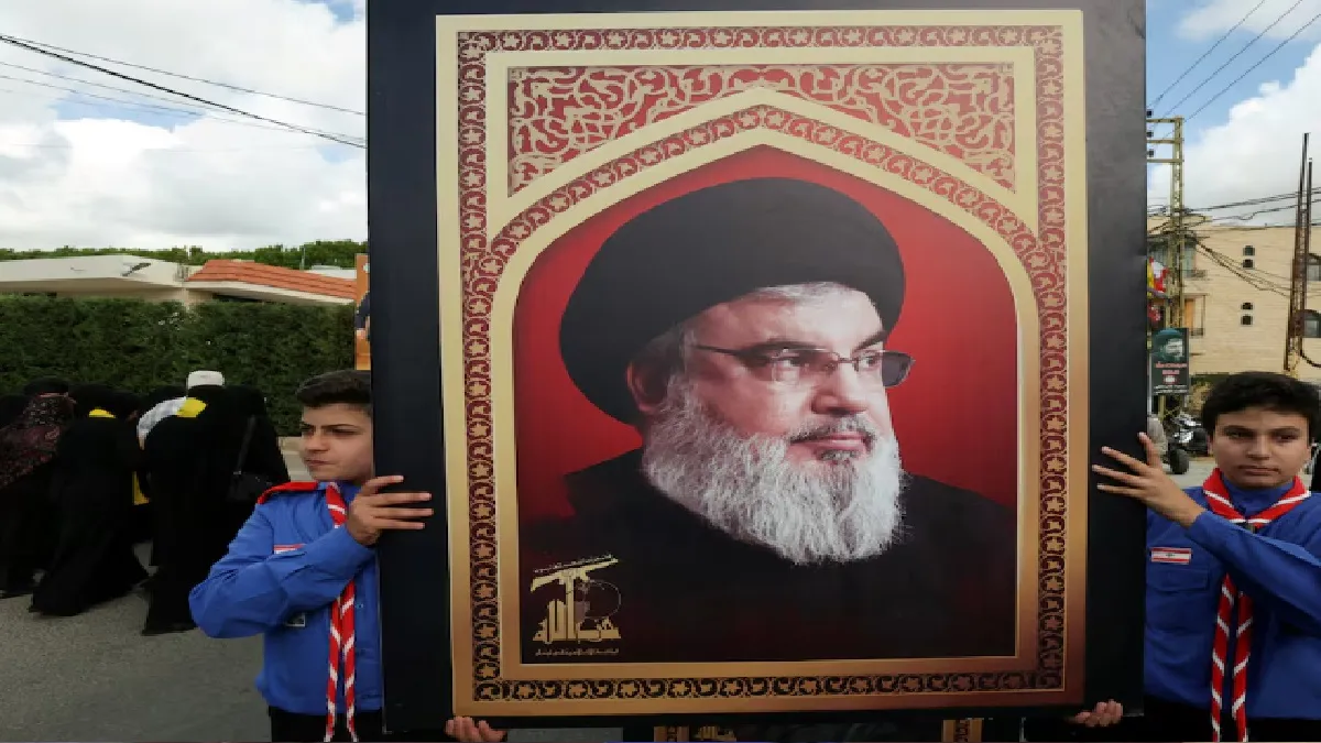 Boys scouts carry a picture of Hezbollah leader Sayyed Hassan Nasrallah 