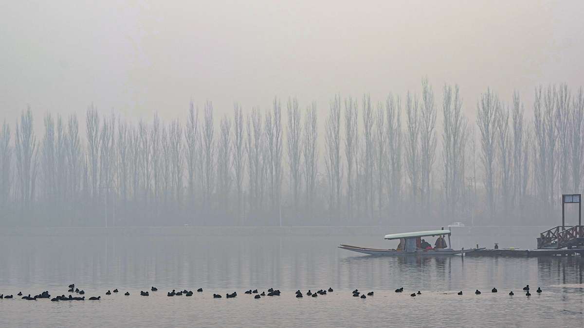 Freezing temperatures grip Kashmir; Dal Lake freezes over.