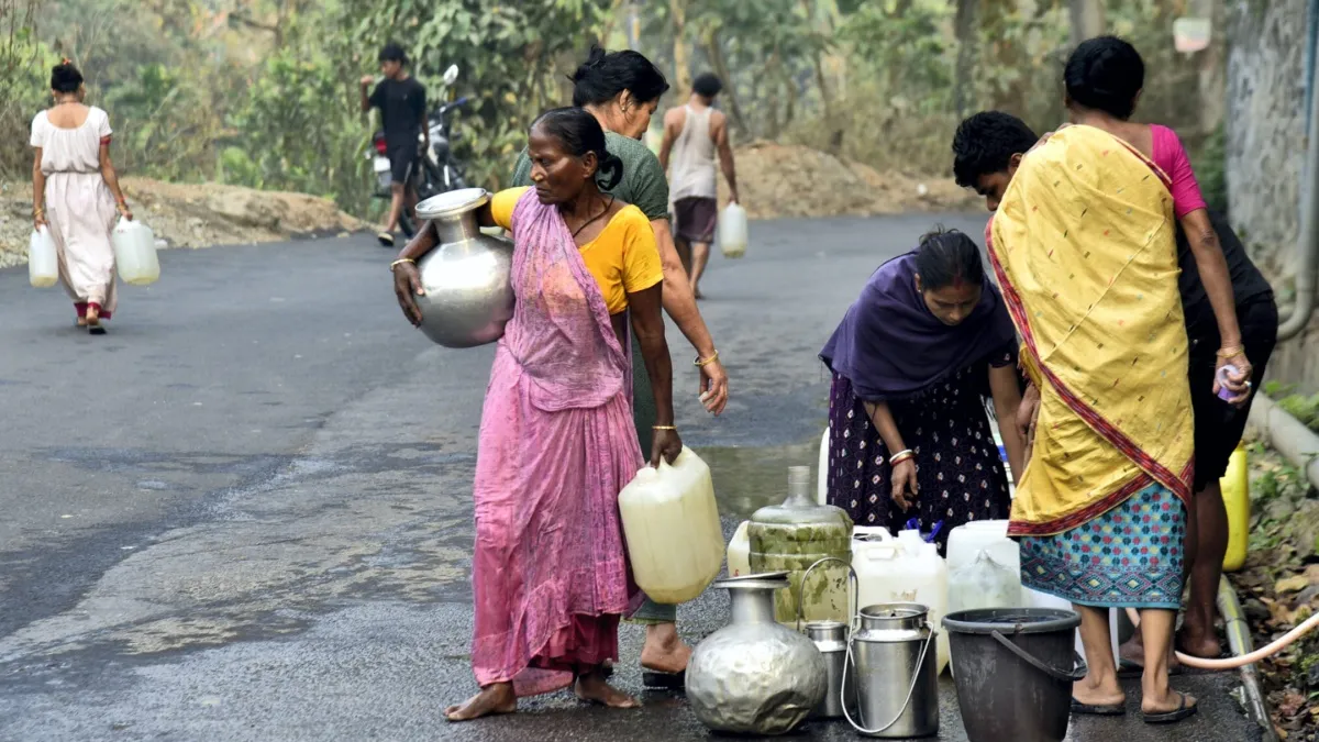 Locals collect drinking water from a roadside water supply.