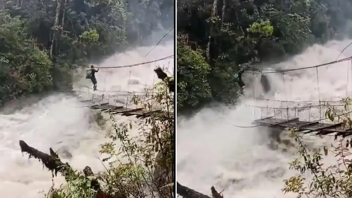 Arunachal man crosses flooded river on traditional rope bridge.