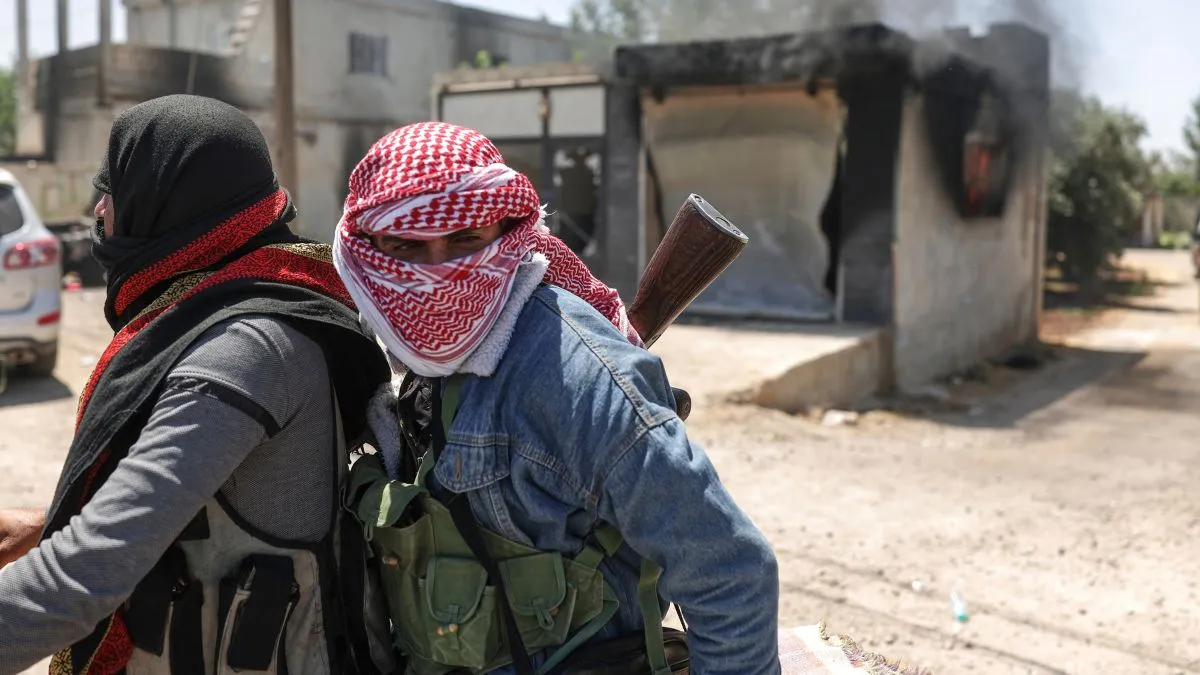 Bedouin fighters deploy at Mazraa village on the outskirts of Sweida city, during clashes between the Bedouin clans and Druze militias.