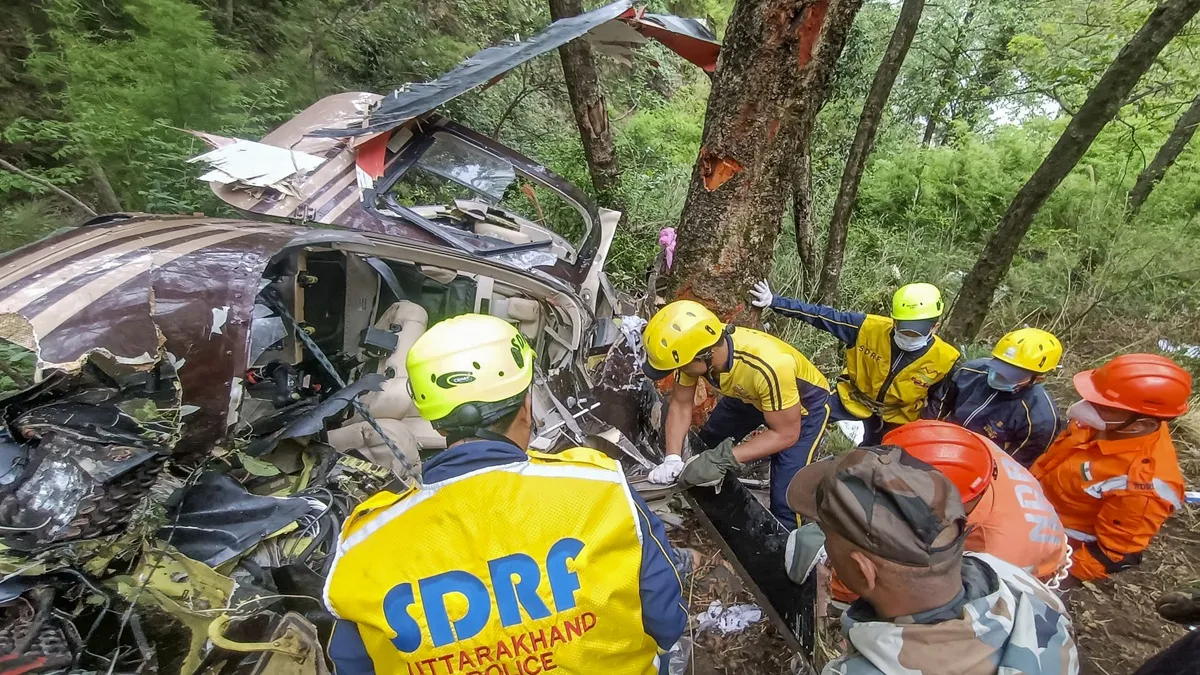 SDRF personnel carry out rescue work after a helicopter carrying six people to Gangotri Dham crashed near Gangnani in Uttarkashi district.

