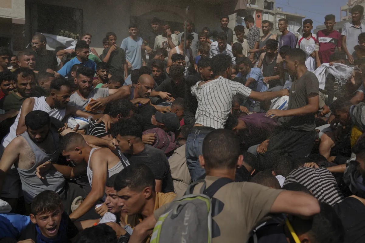 Palestinians struggle to collect humanitarian aid airdropped into Gaza City, northern Gaza Strip.